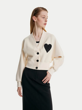 a lady in a cream light air cotton cardigan with a black maxi skirt